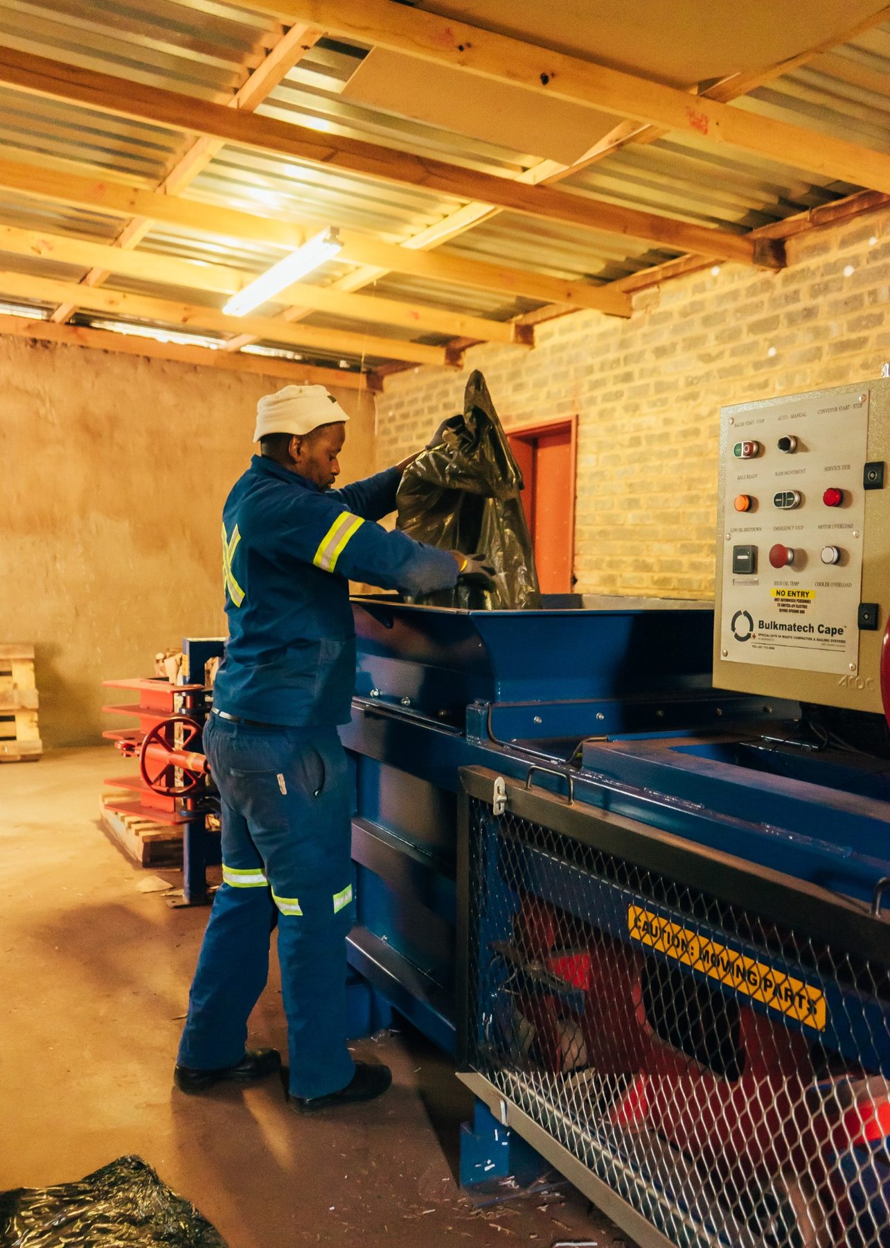 African Eagle employee operating recycling and baling equipment