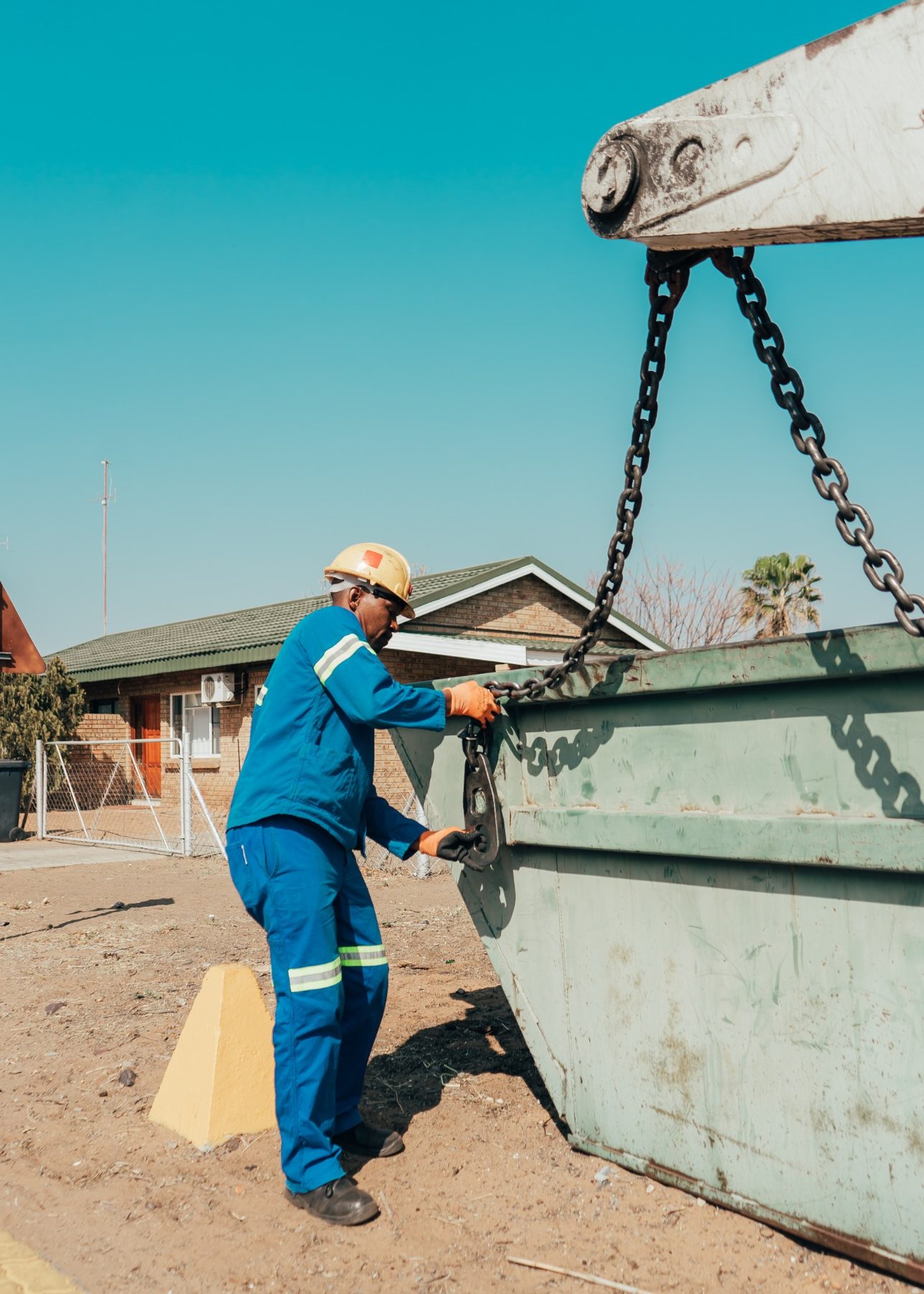 African Eagle employee securing a waste skip for collection