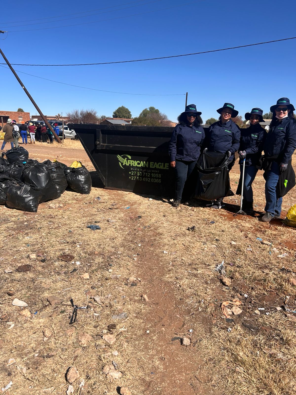 African Eagle team beside waste collected during a community clean-up campaign