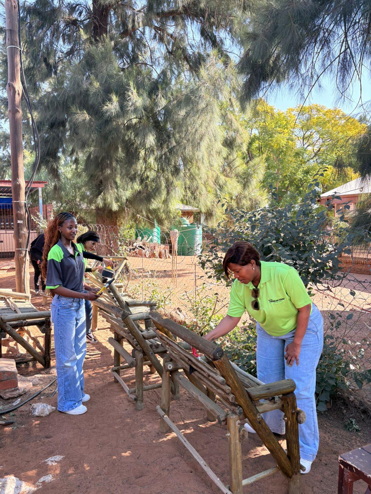 African Eagle team completing outdoor maintenance during Mandela Day
